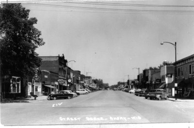 A historical street with buildings and cars on either side
